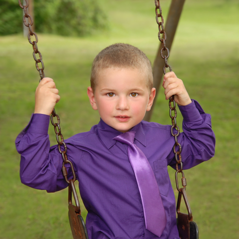 portrait of boy on swing - after