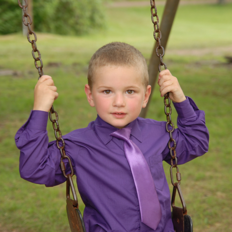portrait of boy on swing - before